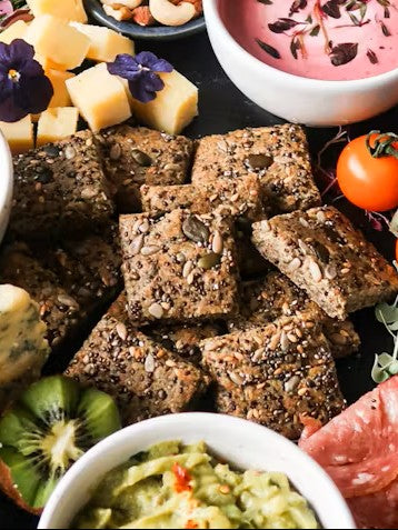 Keto-friendly Spring Grazing board with homemade seeded crackers